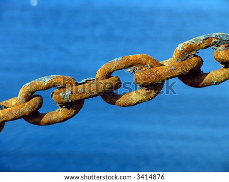 Macro view of a few rusty metal chain ring in high tension