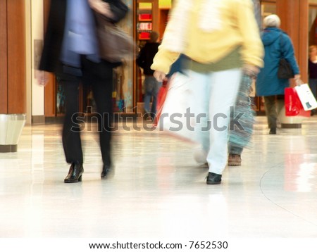 People shopping inside a mall (Blurred motion demonstrates the motion and also protects people privacy)