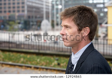 Portrait of man on city street, side profile