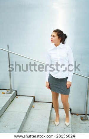 Young woman standing on stairs