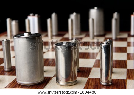 All the common battery types line up on the chess board in this conceptual image which speaks to geopolitical maneuvering over energy policy.