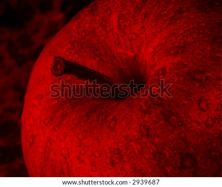 Amazing tone and gothic blood red false color from a simple apple captured in black and white and carefully duotoned with red in post processing. Water drops bead on the skin of the apple.