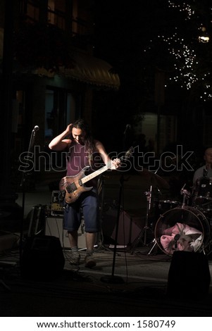 Rock guitarist at an outdoor night concert