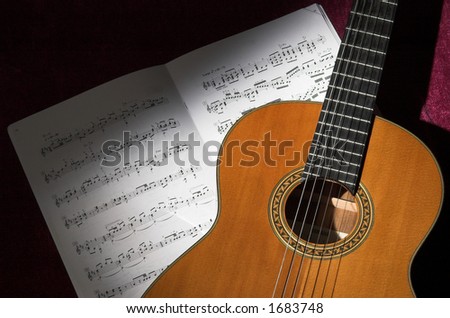 Classical guitar and sheet music still life