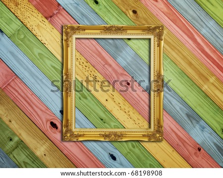Golden Frame on colorful painting wood background