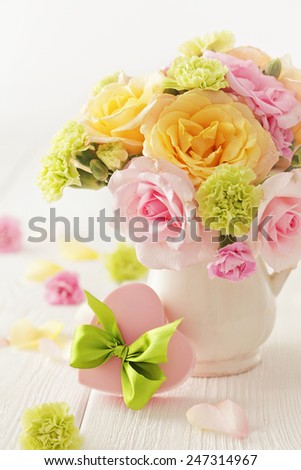 gift box and bouquet of flowers in a vase