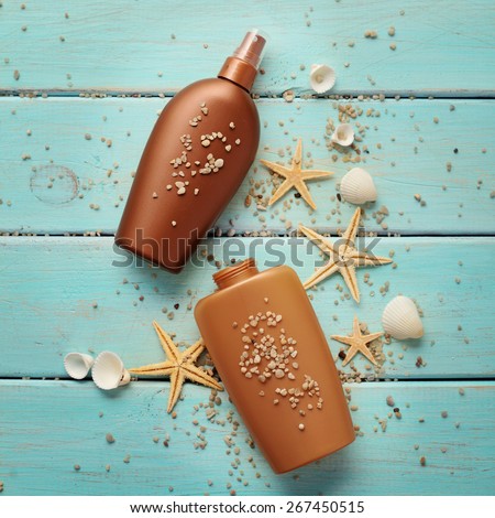 suntan lotion bottles on wooden board