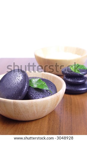 Massage stones and bath salt - Massage stones on wooden background, theme: wellness products, health and beauty, spa products
