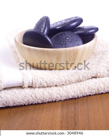 Massage stones- Massage stones on wooden background, theme: wellness products, health and beauty, spa products