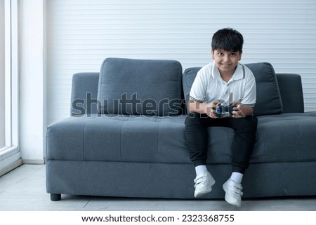 Similar – Image, Stock Photo Concentrated boy playing video game