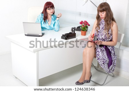 smiling business woman interviewing a young girl