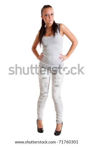 Full-length portrait of sexy young woman in torn white jeans and gray sports jersey
