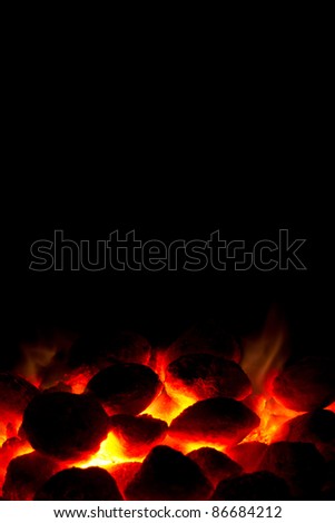 Portrait orientation of hot charcoal fire ready for barbecue with black copy-space