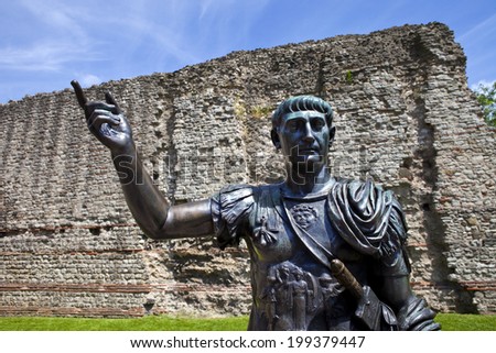 A statue of Roman Emperor Trajan with remains of London Wall which was first built by the Romans in the 2nd and 3rd Centuries AD.
