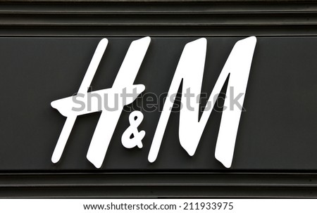 PARIS, FRANCE - AUGUST 4TH 2014: The sign for the \'H&M\' fashion store on Avenue des Champs-Elysees in Paris on 4th August 2014.  Founded in 1947, H&M currently exists in 53 countries worldwide.