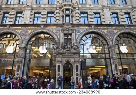 LONDON, UK - NOVEMBER 29, 2014: Crowds of shoppers passing the Apple store on Regent Street in London, on November 29, 2014.  Regent Street is one of the busiest shopping streets in central London.