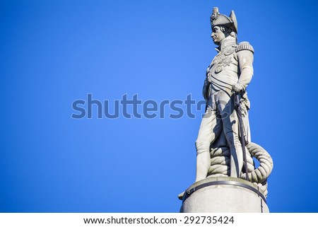 The statue of Admiral Horatio Nelson proudly sitting on top of Nelsons Column in London.