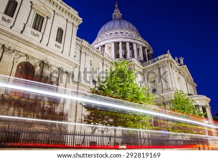 A night-time view of light trails passing the historic St. Pauls Cathedral in London.