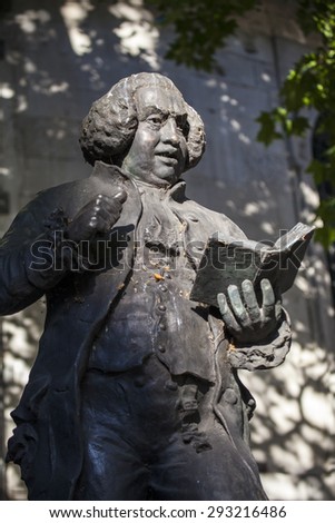 LONDON, UK - JUNE 30TH 2015: A statue of famous Briton, Dr Samuel Johnson located outside St. Clement Danes church on the Strand in London, on 30th June 2015.