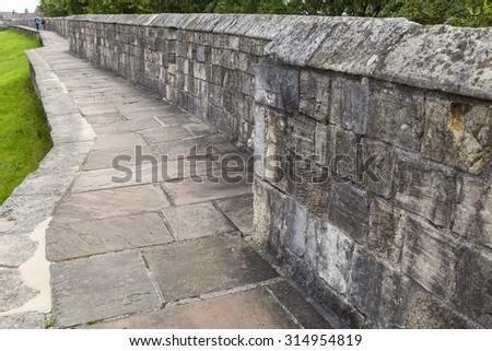 YORK, UK - AUGUST 25TH 2015: The historic York City Walls in York, on 25th August 2015.  Since Roman times, the city has been defended by walls and substantial portions of these still remain today.