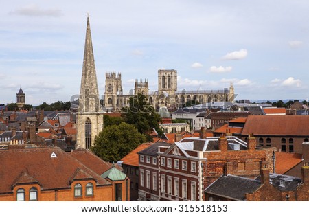 YORK, UK - AUGUST 30TH 2015: Looking out at the view from the top of Cliffords Tower in York, on 30th August 2015.  The sights include York Minster, St Wilfrids Catholic Church and St. Marys Church.