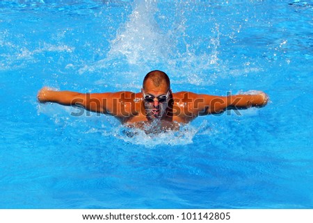 Athletic swimmer training hard in a swimming pool