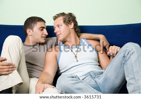 Two homosexual man sitting on the sofa