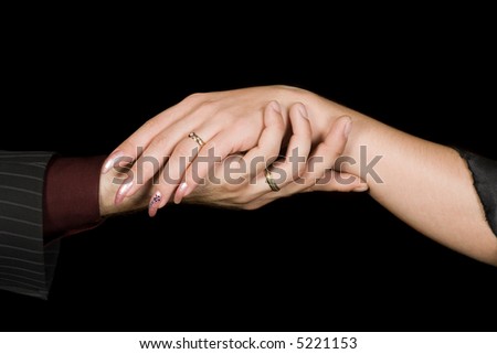 Man\'s and woman\'s hands isolated on black