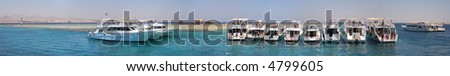 Row of diving boats moored around Gordon reef on Straits of Tiran, Red Sea, Egypt
