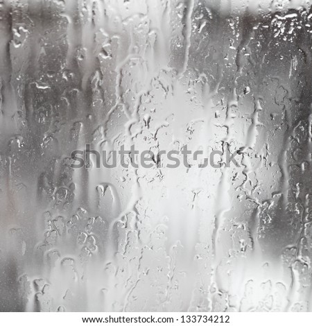 abstract background rain streams on home glass window