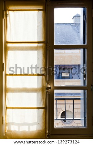 white textile drapes on sunny window