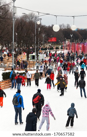 MOSCOW, RUSSIA - JANUARY 2, 2013: crowds of townspeople skating rink on ice covered paths in Gorky Central Park on winter weekends. This is Europe\'s largest artificial ice rink area 18 000 sq m