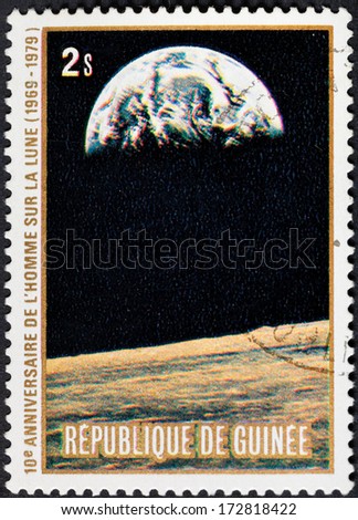 REPUBLIC OF GUINEA - CIRCA 1979: A postage stamp printed in the Republic of Guinea shows the Apollo 11 Moon Landing and first step on The Moon surface - view of Earth, circa 1979