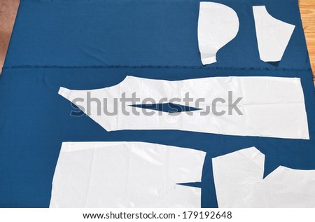 paper model of apparel on blue fabric for dress cutting