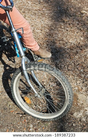 girl on bicycle on country road in sunny day