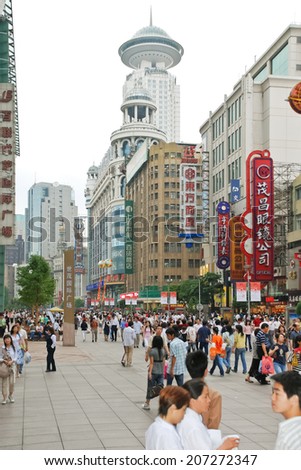 SHANGHAI, CHINA - JUNE 3, 2007: many people on Nanking Road (Nanjing Road) - main shopping street of Shanghai, China. This street is Shanghai's busiest, most westernized shopping street.