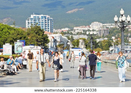 YALTA, RUSSIA - SEPTEMBER 30, 2014: tourists walking on promenade in Yalta city in September . Yalta is resort city on the north coast of the Black Sea on the Crimean peninsula.