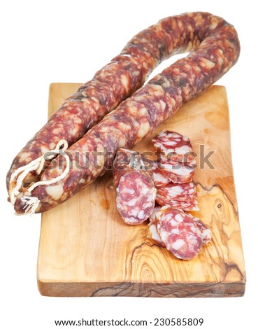 dried smoked sausage on chopping wooden board isolated on white background