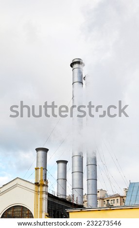smoke from chimneys of district heating station in autumn day