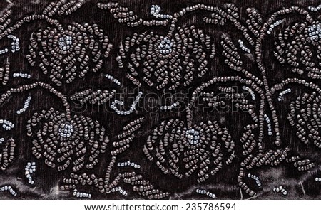 vintage embroidery by black beads on black velvet close up