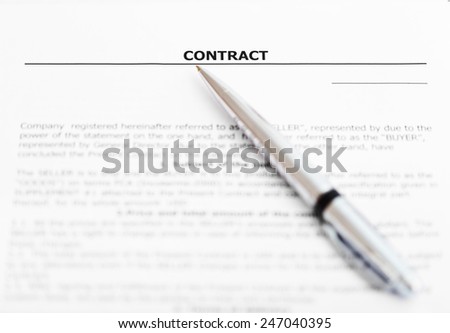 silver pen on sheet of sales contract close up