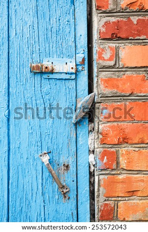 blue painted old wooden door with latches close up