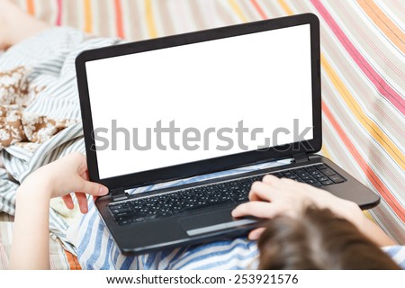 girl works on laptop with cut out screen in living room