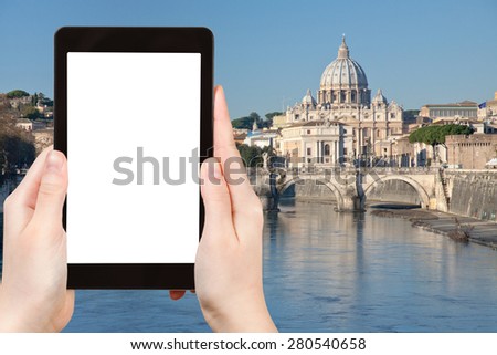 travel concept - tourist photograph view of Tiber river and St Peter Basilica in Rome, Italy on tablet pc with cut out screen with blank place for advertising logo