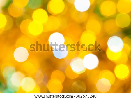 abstract blurred background - yellow and green flickering Christmas lights bokeh of electric garlands on Xmas tree