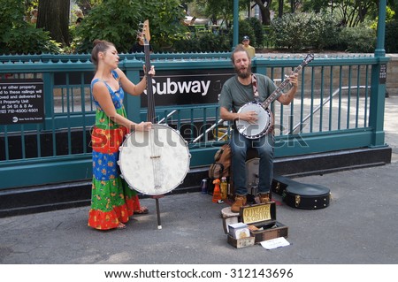New York, New York - August 29, 2015 - Two street buskers under the name Coyote & Crow perform old-time music at New York City's Union Square Park.