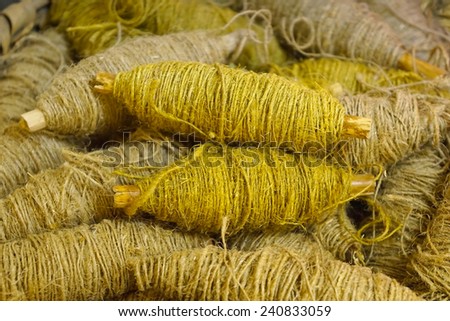 old bobbin with yellow jute rope