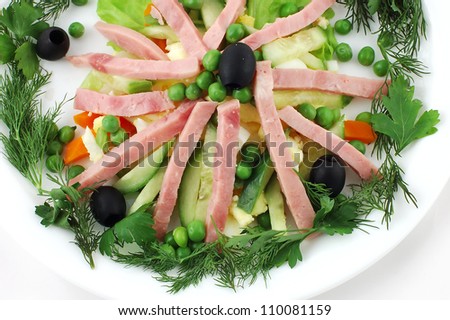 Salad with olives and cheese from fresh vegetables on a white background