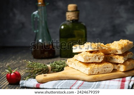 Similar – Image, Stock Photo Homemade Italian Focaccia, with tomato and olive oil on a rustic wooden background.