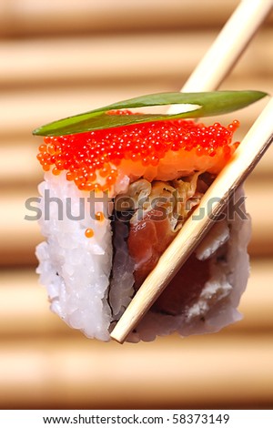sushi with red caviar on the Chinese sticks